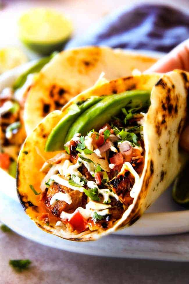 These are ADDICTINGLY DELICIOUS!  Honey Chipotle Chicken Tacos stuffed with wonderfully juicy, flavor packed Honey Chipotle Bacon Chicken (yes BACON chicken!), piled with crispy BLT Slaw and creamified with Cilantro Lime Crema!  