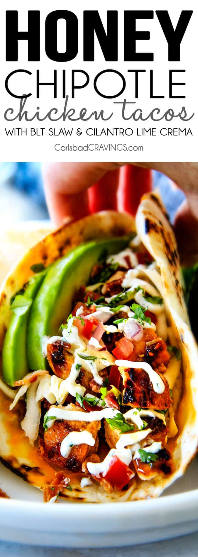 up close of Chipotle Chicken Tacos piled with honey chipotle chicken, tomatoes and avocados 