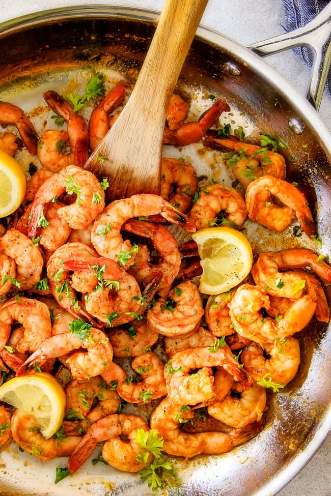 top view of Old Bay Shrimp (Grill or Stove top) in a skillet garnished by lemons