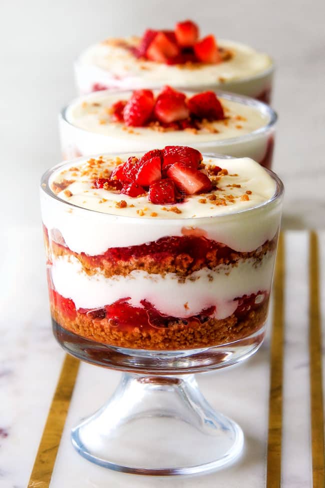 Strawberry Cheesecake Parfaits showing layers in a glass cup. 