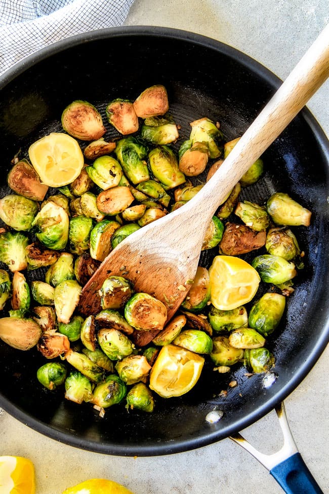 showing how to cook Brussels sprouts in a black skillet for Sautéed Brussels Sprouts recipe