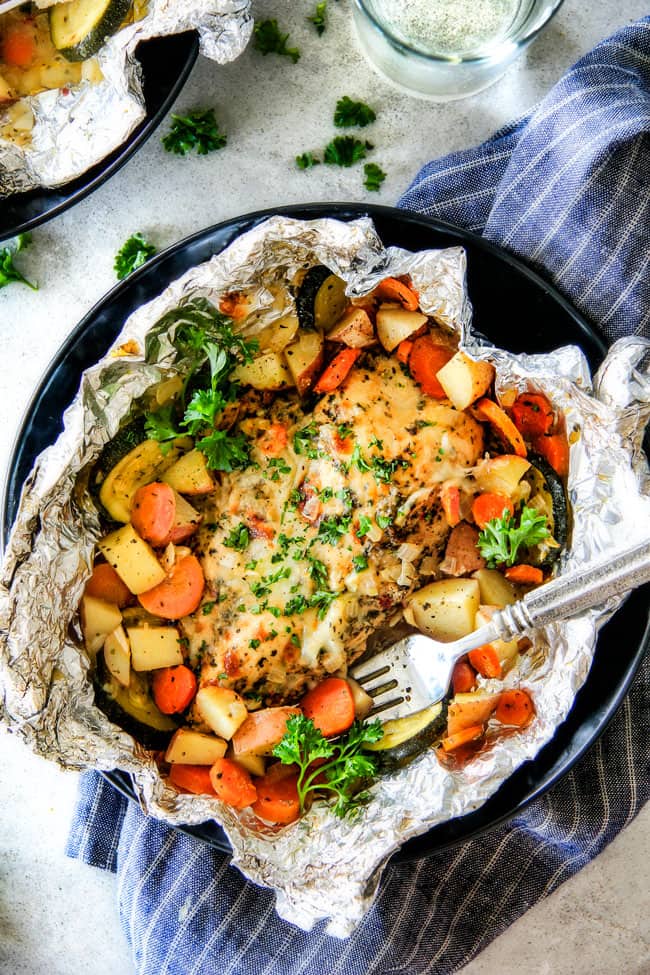 Baked or Grilled Italian Mozzarella Chicken Foil Packets are bursting with astonishingly juicy, flavorful chicken and tender, seasoned Potatoes, Carrots and Zucchini all smothered with Mozzarella Cheese!  These foil packets are meal-in-one that are quick to throw together and even quicker to clean up! 