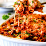 This Million Dollar Baked Penne has been a family favorite for decades!  We serve it at all our family gatherings because its SO good, so easy!  The homemade sauce is incredible and the hidden layer of creamy/cheesiness is to live for! 