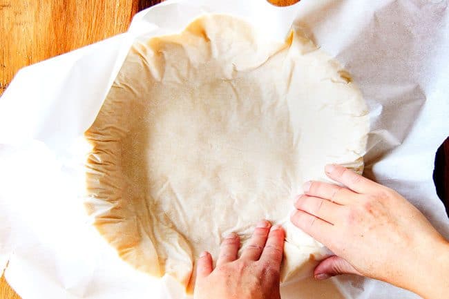 showing how to make pie  crust by flipping dough into a pie plate