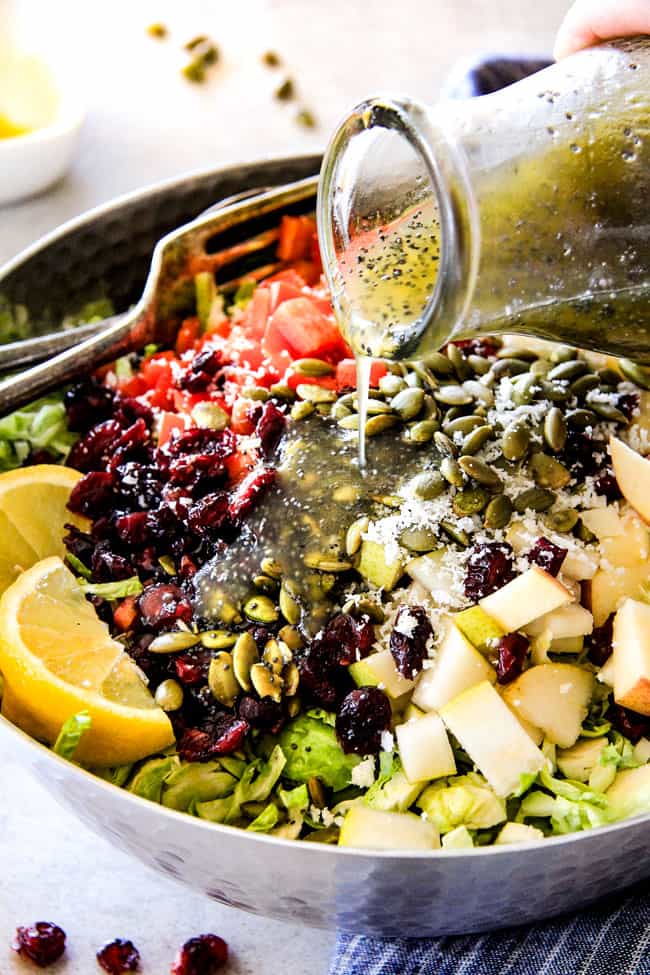 Cranberry Apple Brussels Sprouts Salad with dressing poured over top. 