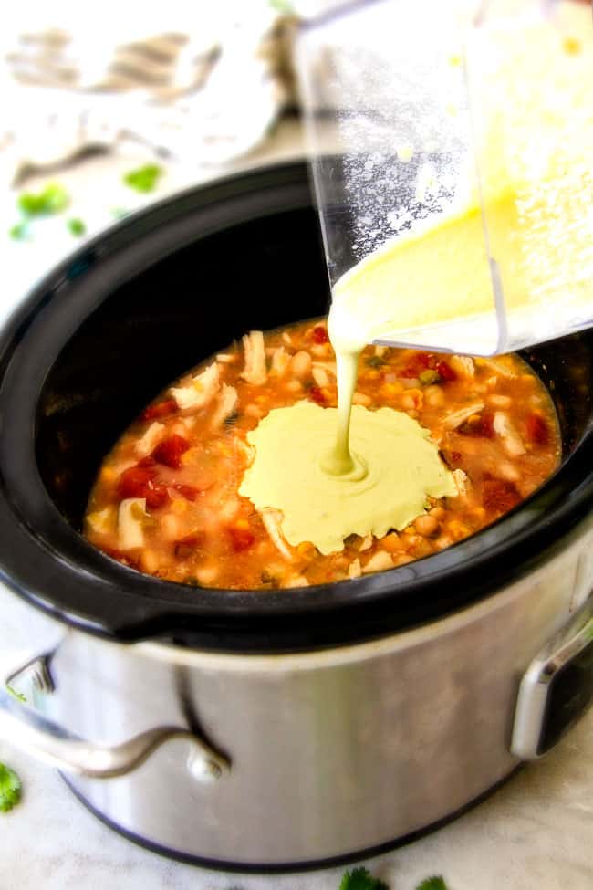 Mixing Crockpot Creamy White Chicken Chili in the crockpot. 