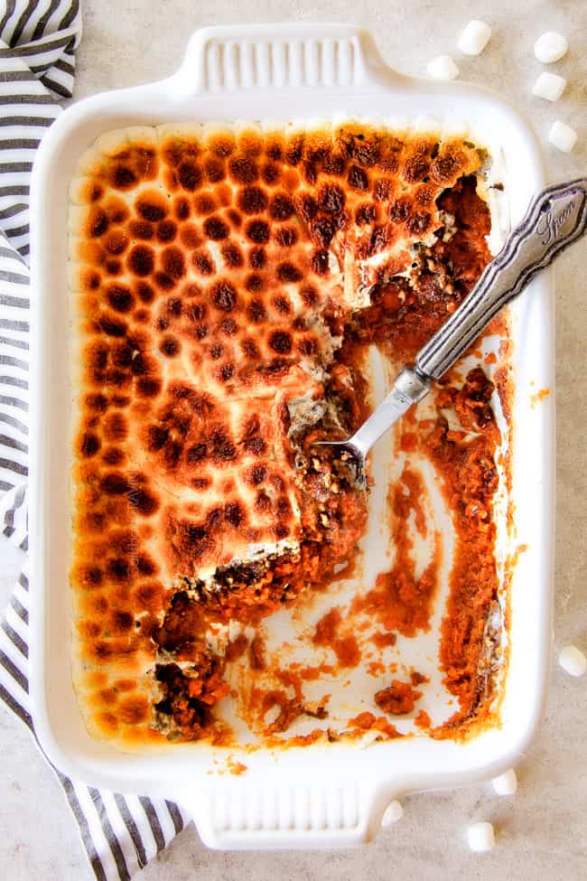 The best ever  Sweet Potato Casserole with Marshmallows AND buttery, brown sugar Pecan Topping!  This Sweet Potato Casserole has been our favorite recipe ever since we tasted it almost a decade ago and you will love that you can assemble it the night before Thanksgiving or Christmas!  No Thanksgiving table is complete without this comforting classic!