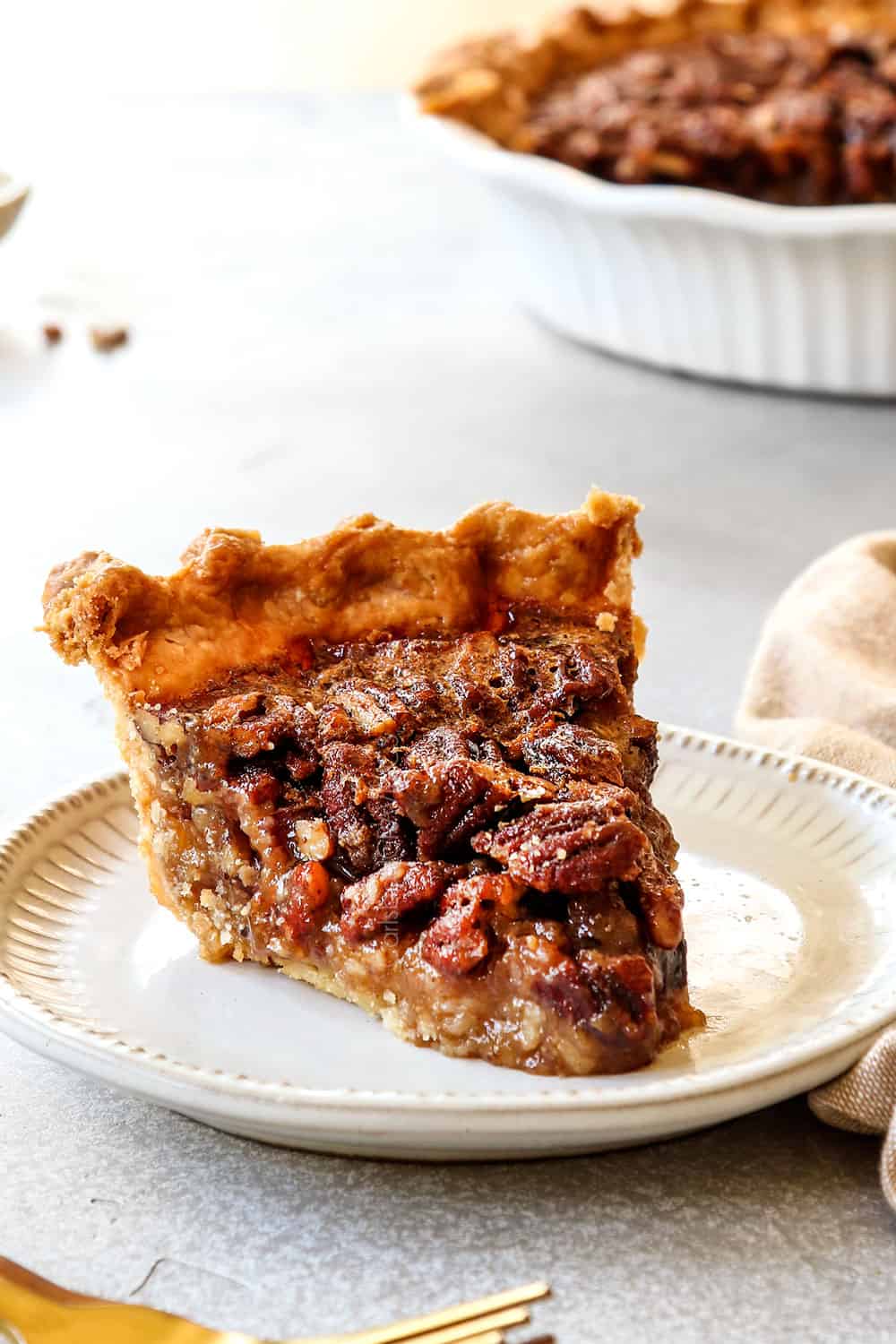 a slice of homemade pecan pie on a plate