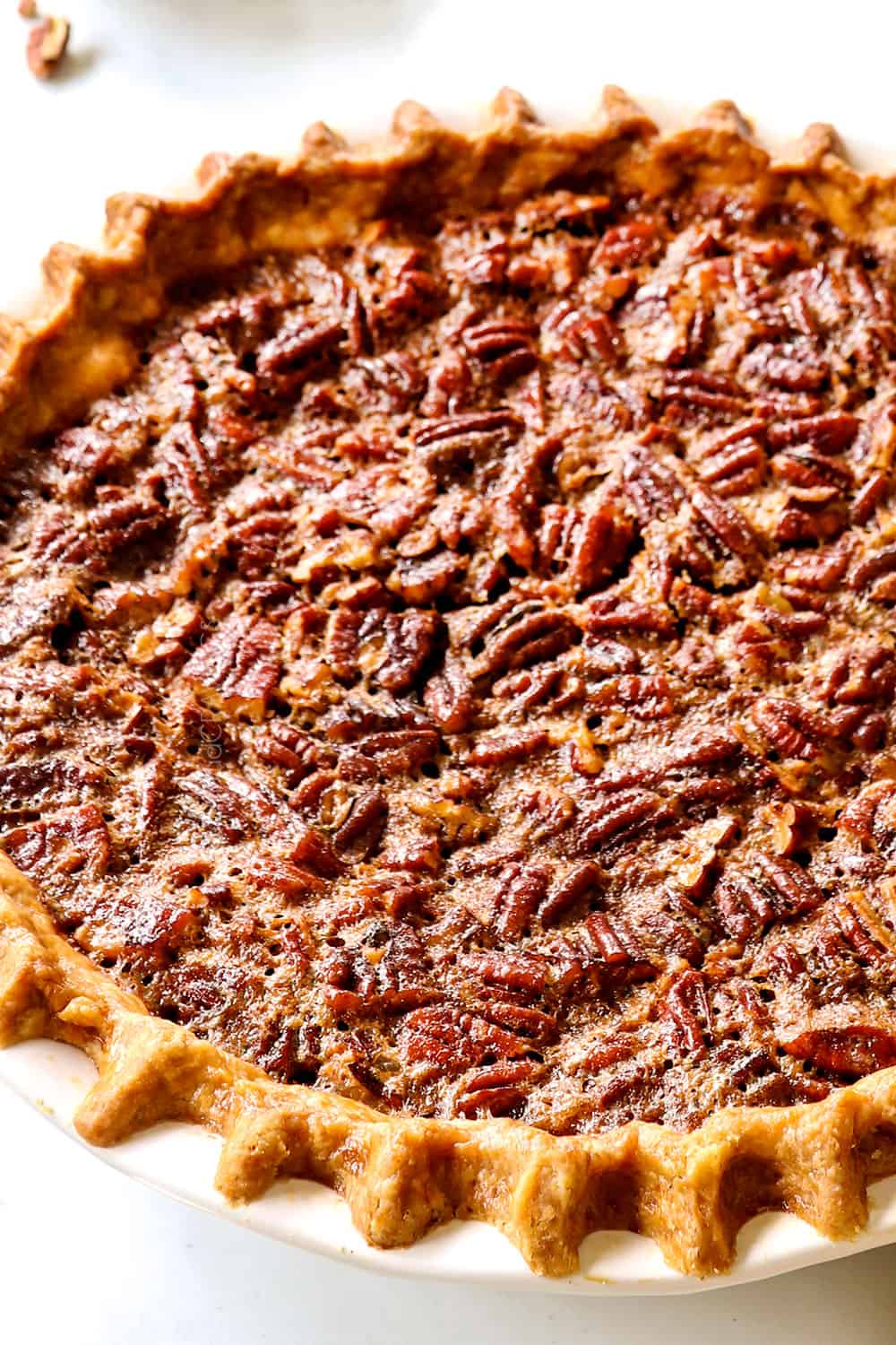 side view of easy pecan pie showing the toasted pecan topping