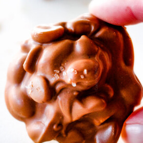 FOOL PROOF Crockpot Chocolate Peanut Clusters are not only crazy delicious but are SO easy!  They make the best make ahead, stress free gifts!  This post also includes tips and tricks to make them successful every time!