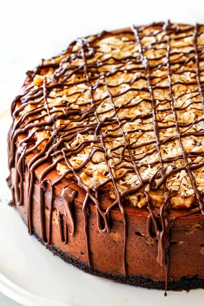 German Chocolate Cheesecake AKA the best German Chocolate anything! The rich and creamy chocolate cheesecake has a hidden layer of traditional caramel-eaque sweet and crunchy Coconut Pecan Frosting and another layer on top! This cheesecake is to live for!