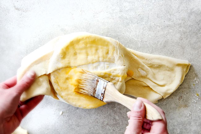 showing how to fold baked brie in puff pastry 