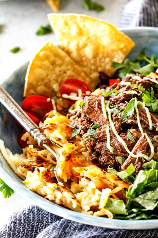 Barbacoa Beef Taco Bowls with Hash Browns & Avocado Ranch in a bowl with chip garnish.