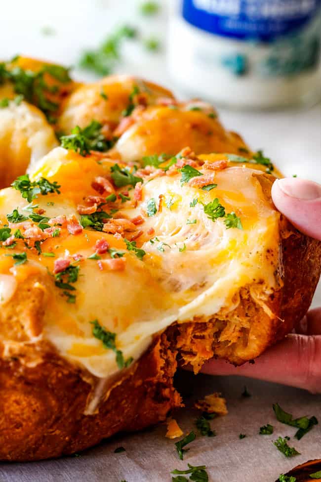 pulling a cheesy biscuit away from the Buffalo Chicken Pull Apart Bread 