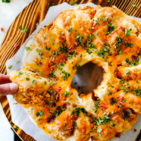 Mega flavorful Buffalo Chicken Dip Ring is your favorite decadent creamy, cheesy dip baked right into a buttery biscuit ring! Crazy delicious EASY crowd pleasing appetizer perfect for parties or game day!  It may look super impressive but you won’t believe how easy it is!