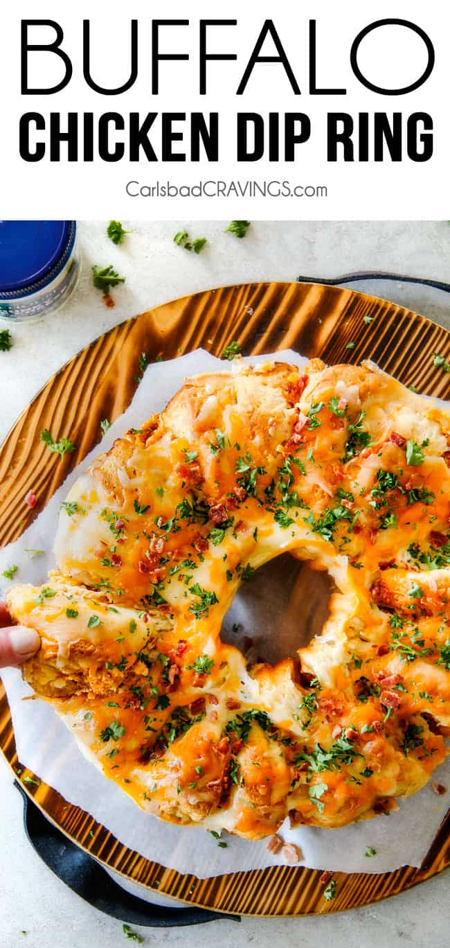 top view of cheesy Buffalo Chicken Pull Apart Bread with biscuits on a cutting board garnished with parsley