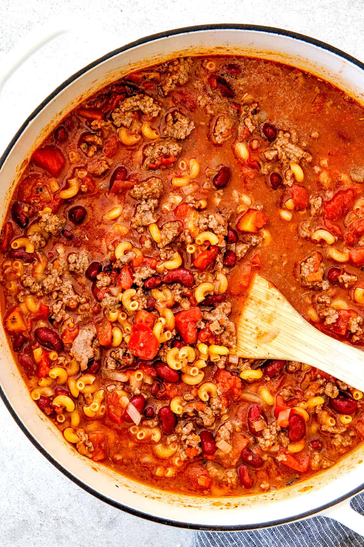 up close of making chili mac by simmering everything together in one pot