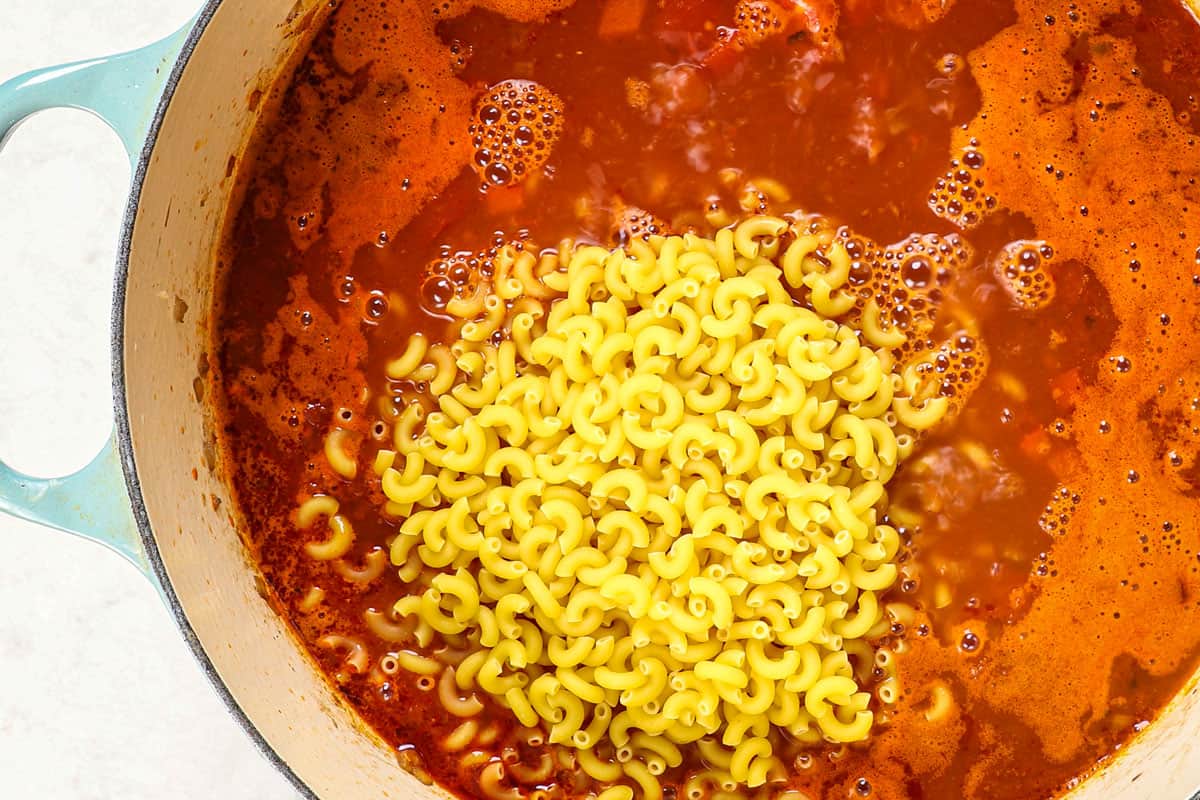 showing how to make chili mac by adding elbow pasta to cook in the same pot