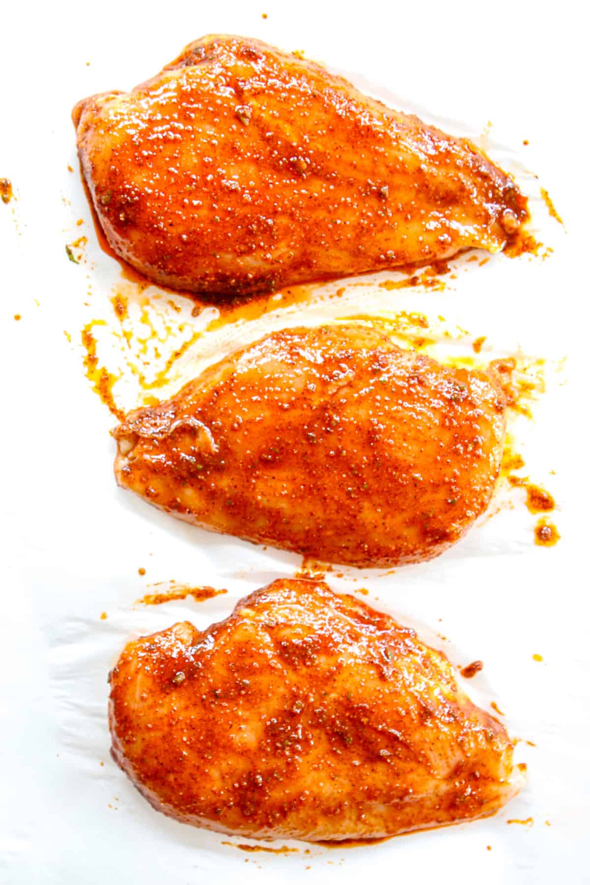 showing how to make chili lime chicken by marinating the chicken in the wet rub