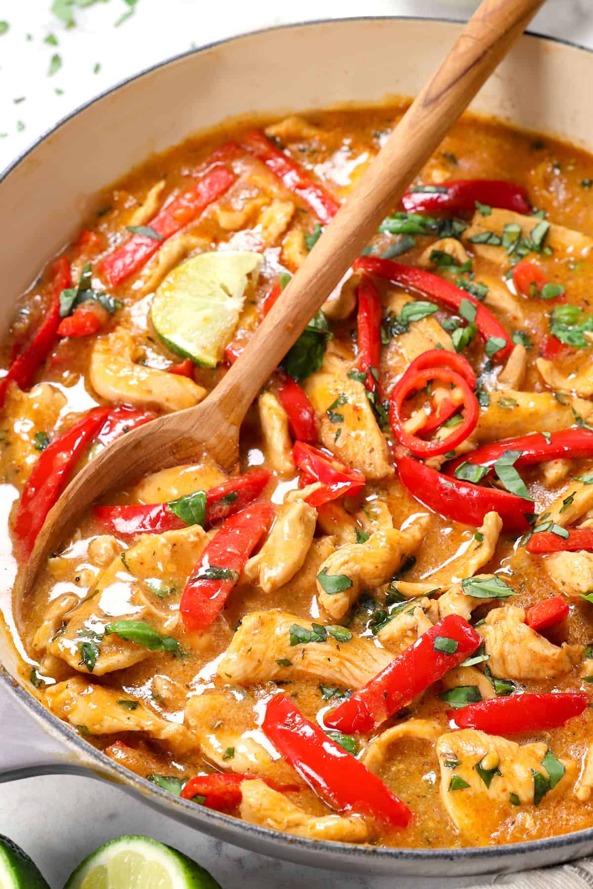 a serving spoon of panang curry chicken showing how creamy it is