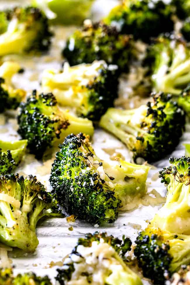 showing how to make oven roasted broccoli by spreading broccoli in an even layer on a baking sheet