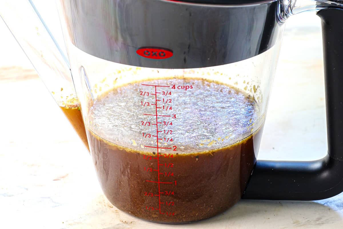 showing how to cook a roast in the oven by straining the grease from the pot roast drippings to make gravy