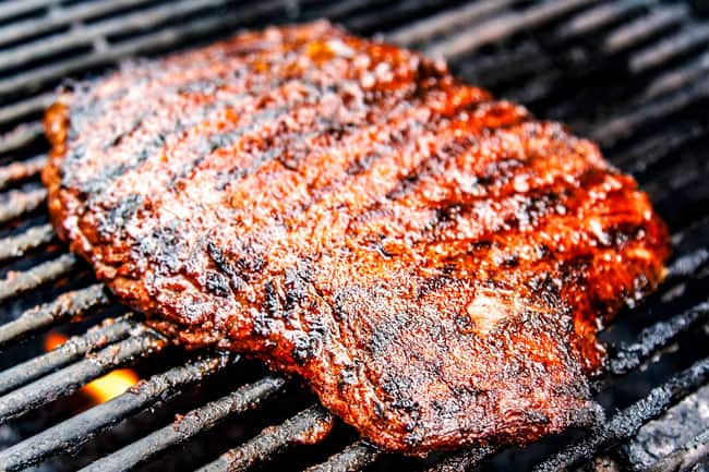 showing how to make grilled steak fajitas by adding marinated steak to a hot grill