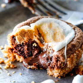 EASY - 30 Minute - S'mores Molten Lava Pies are decadently rich, with an oozing chocolate center, topped with melty toasted marshmallows all nestled in a buttery graham cracker crust - BUT - they are super easy to make and baked in a muffin tin so no special equipment is required!