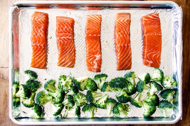 showing how to make Honey Soy Salmon by lining salmon in a row on a baking sheet