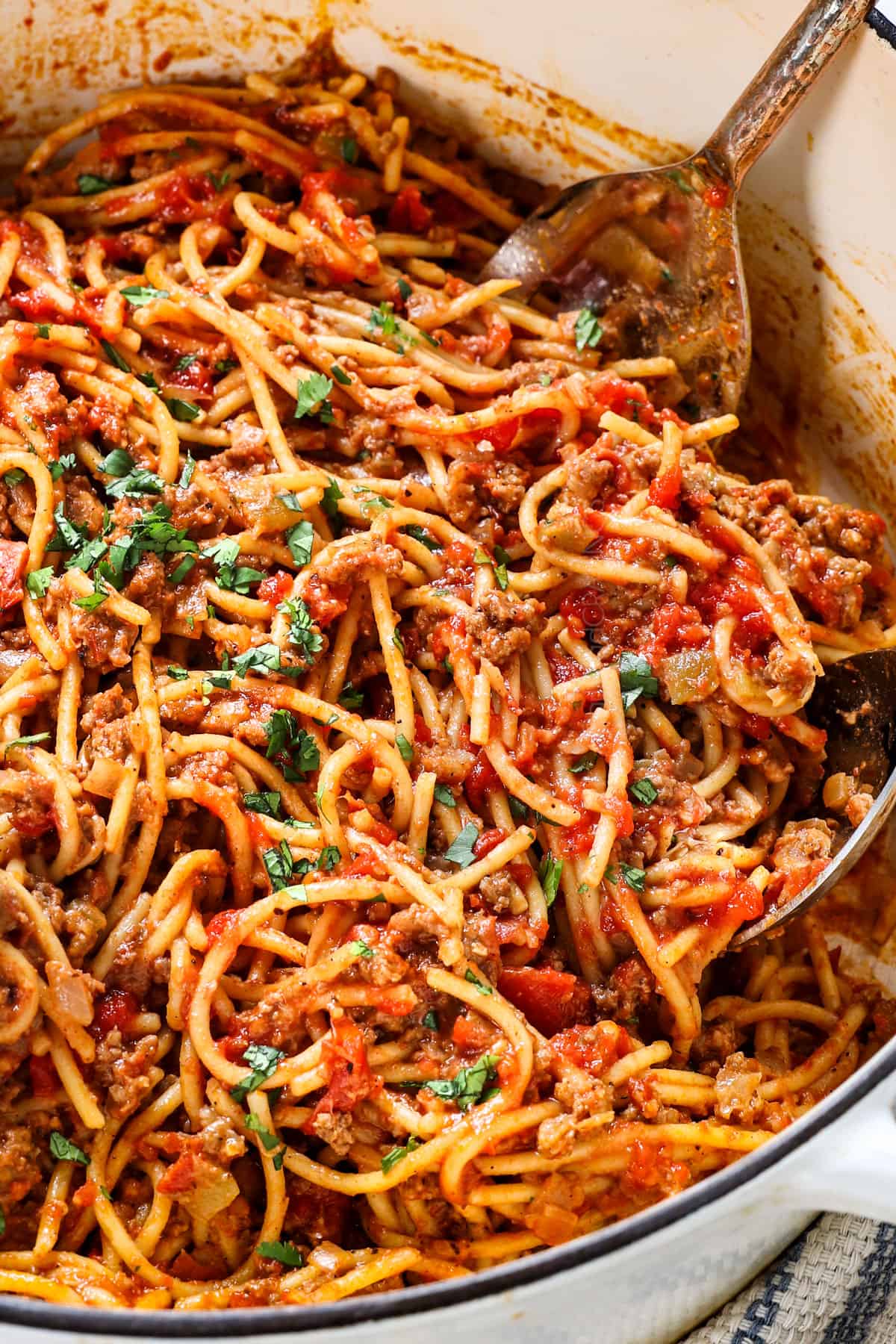 tossing taco spaghetti together with sauce