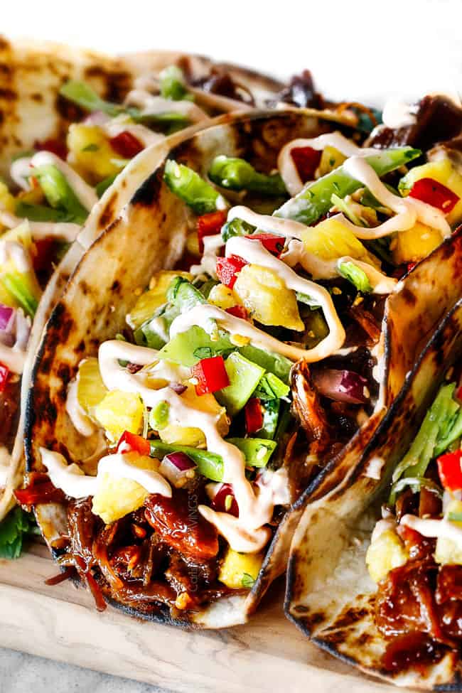 Up Close of Pulled Pork Taco with Pineapple Slaw on a cutting board