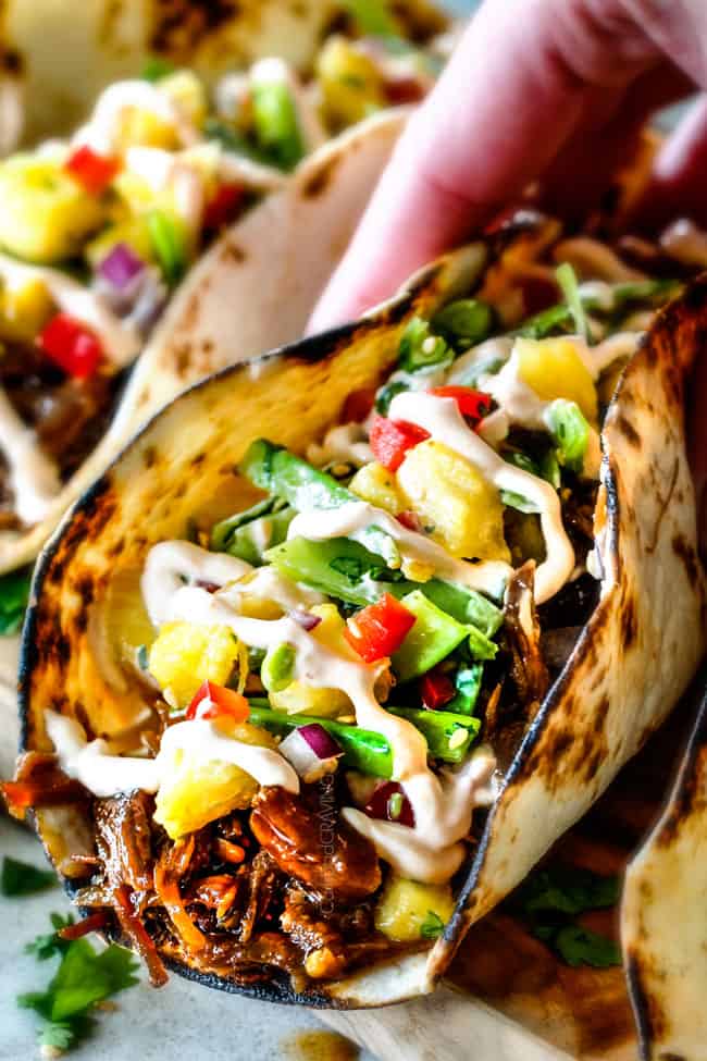 Up Close of Pulled Pork Taco with slaw on a cutting board