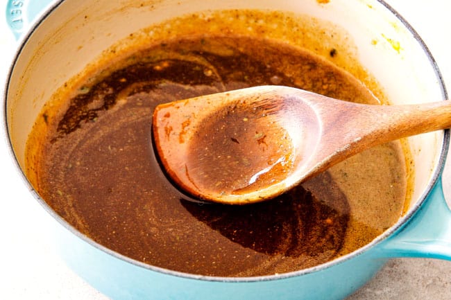 Showing how to make Brown Sugar Glaze for Ham by simmering brown sugar, honey, Dijon mustard, yellow mustard, cinnamon, nutmeg, cloves and spices together