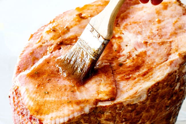 Showing how to Cook a Precooked Ham by slathering ham with Brown Sugar Glaze for Ham