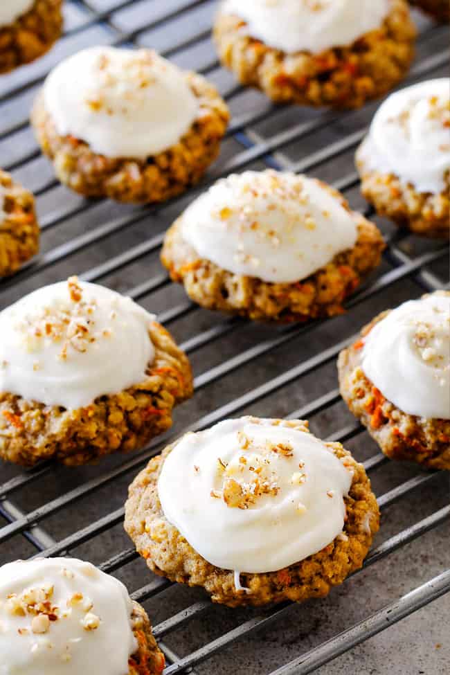 Easy Carrot Cake Cookies on a wire rack with Cream Cheese Frosting and a sprinkling of pecans