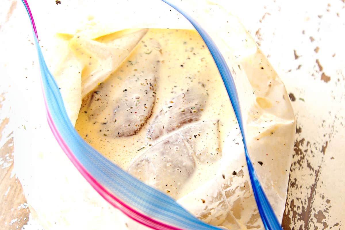 showing how to make oven fried chicken by marinating the chicken in buttermilk and spices