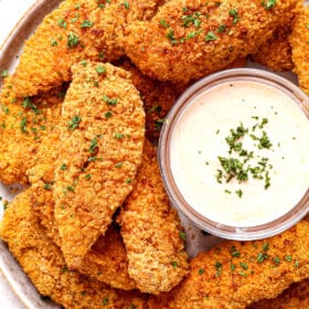 top view of serving oven baked fried chicken on a platter with dipping sauce