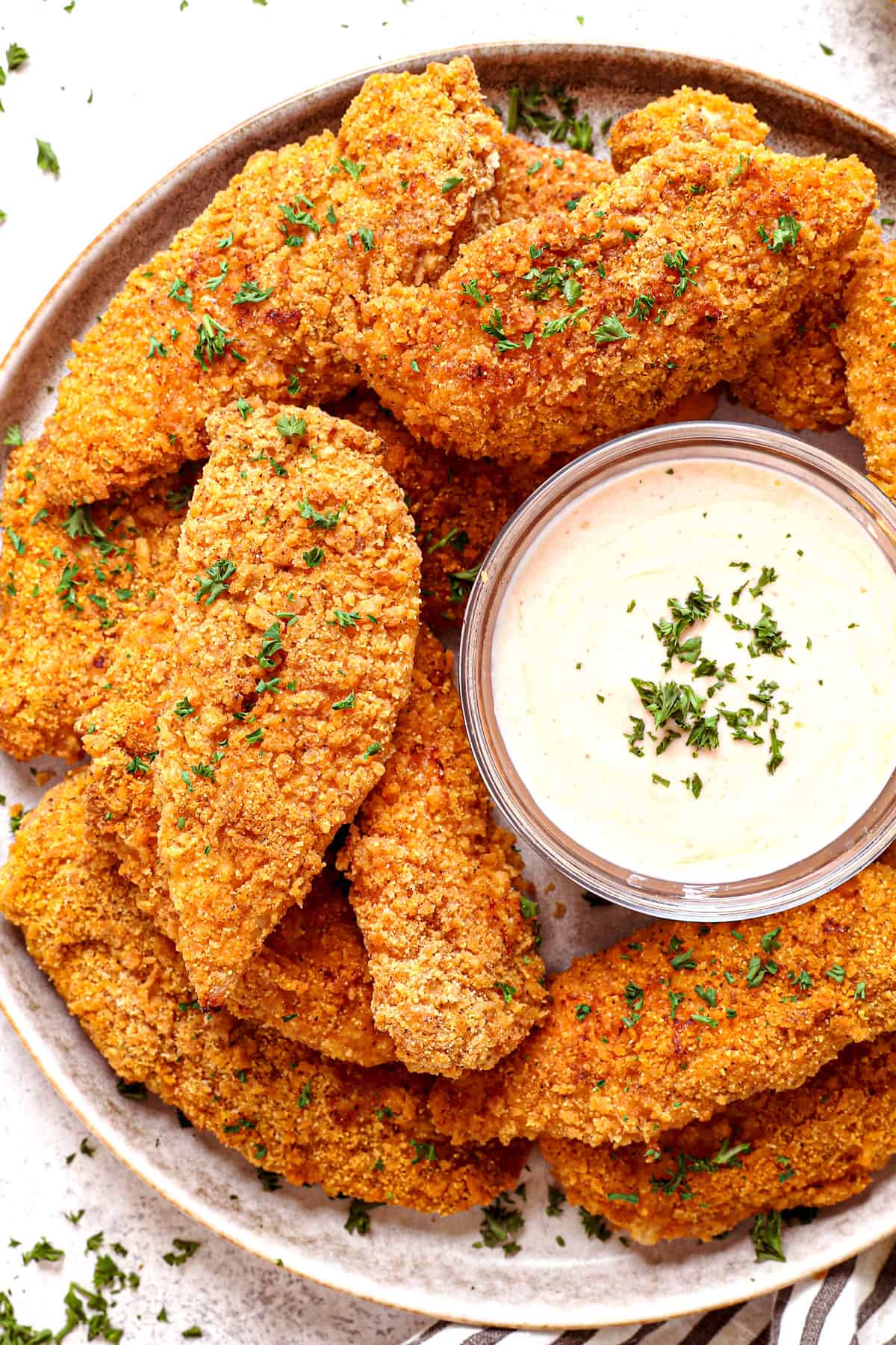 top view of serving oven baked fried chicken on a platter with dipping sauce