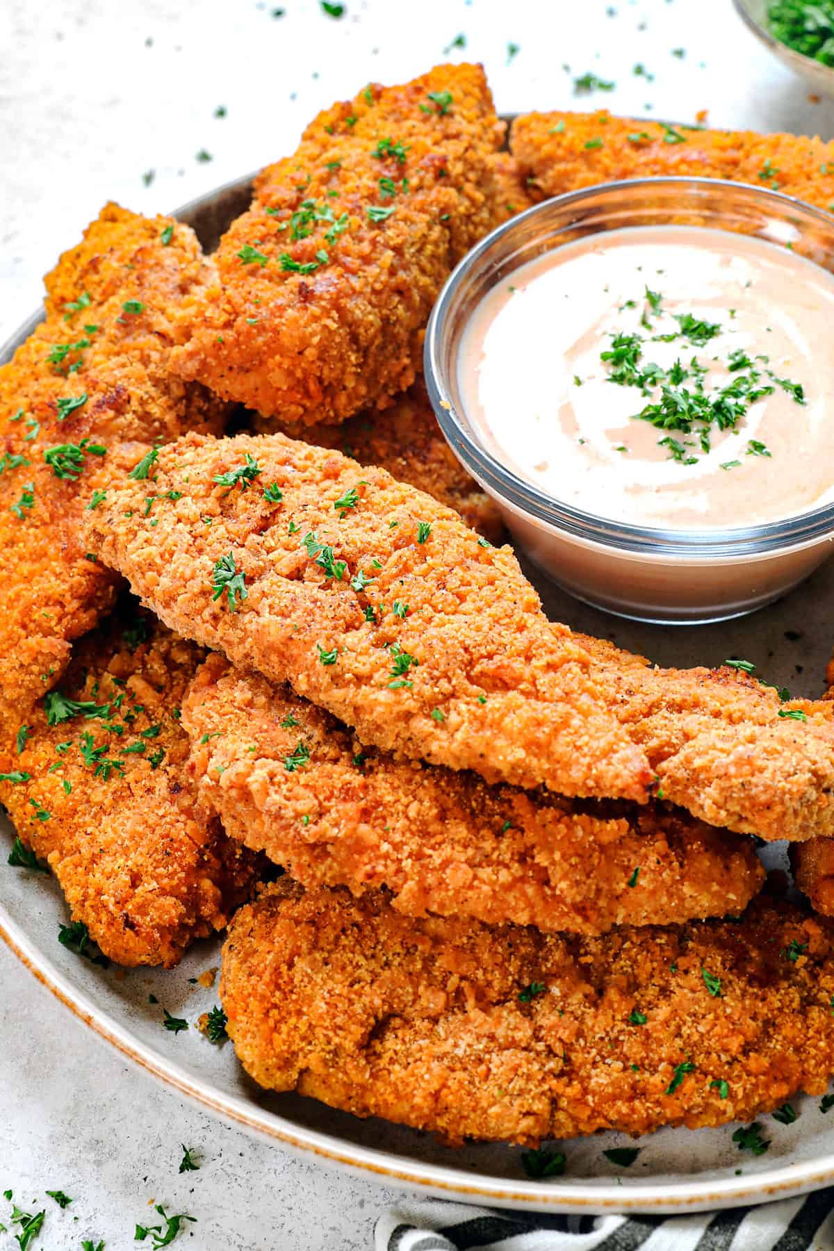 baked fried chicken recipe stacked on a platter