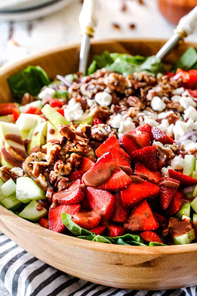 side shot of Strawberry Spinach Salad with balsamic dressing, strawberries, cucumbers and toasted ramen