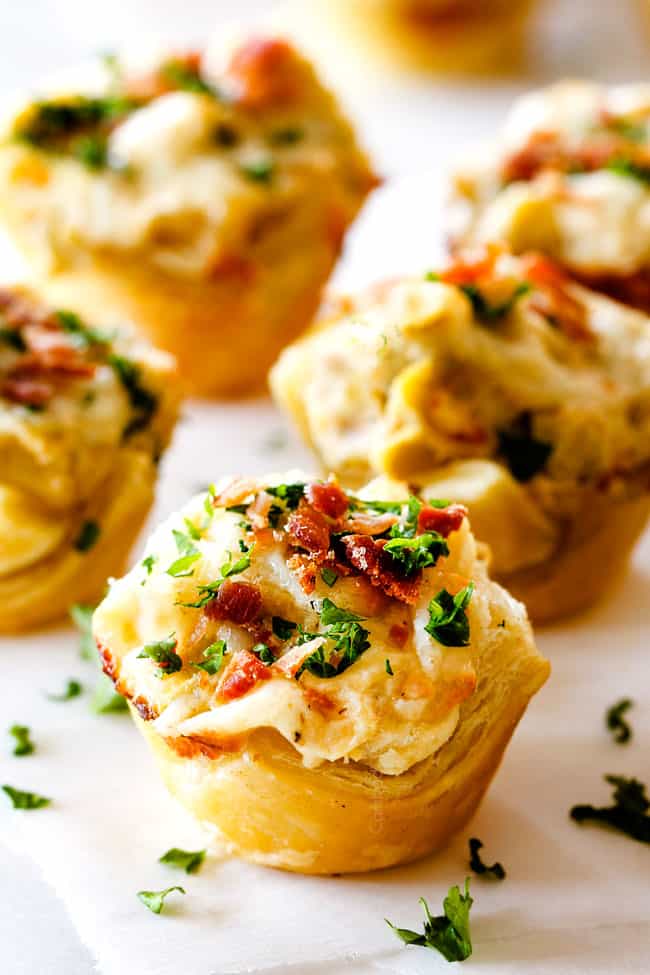 up close shot of Artichoke Dip Bites on a white marble pedestal