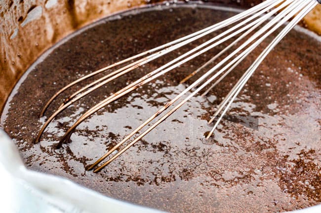 whisking together cocoa powder, hot water with dry ingredients in a stainless steal bowl for best Chocolate Raspberry Cake