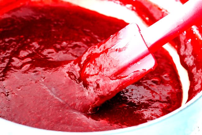 showing how to make homemade raspberry jam by simmering raspberries, lemon juice and sugar in medium saucepan for Chocolate Cake with Raspberry Filling