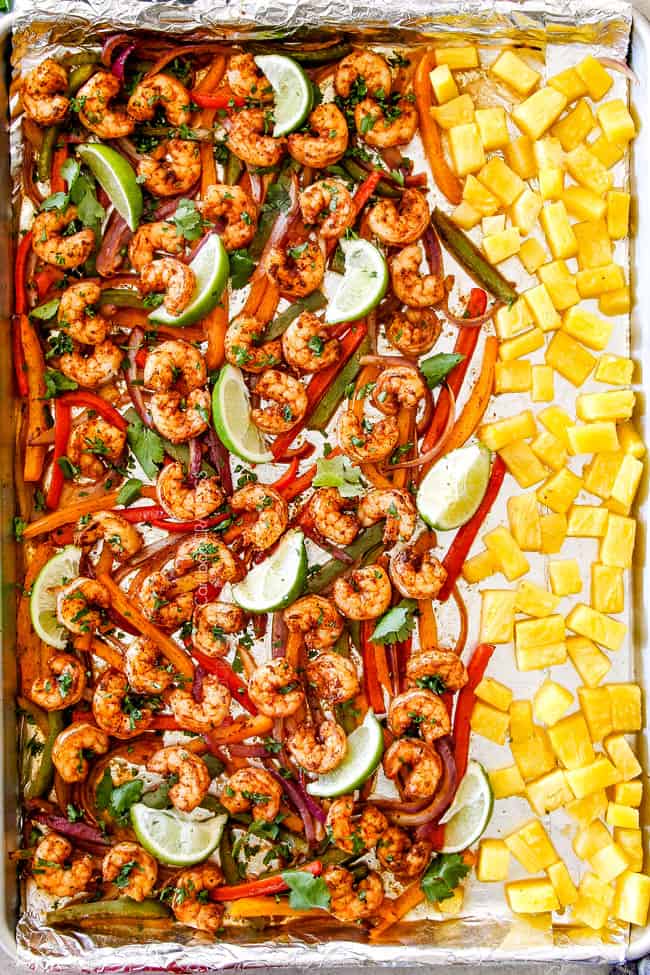 top view of shrimp fajitas in oven with rice, black beans, sour cream