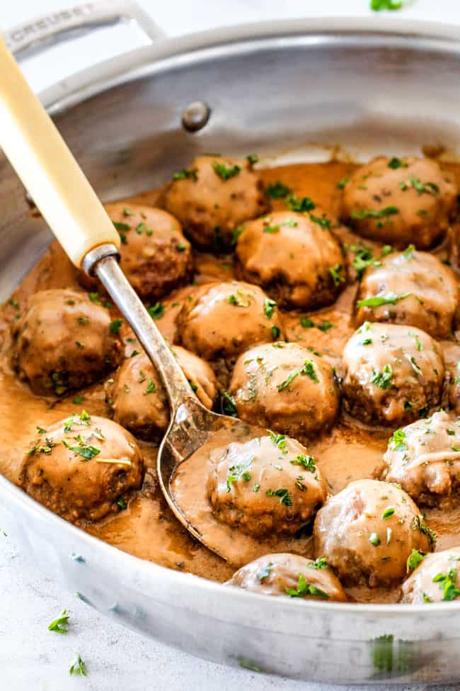 authentic Swedish Meatballs in a silver skillet with a serving spoon