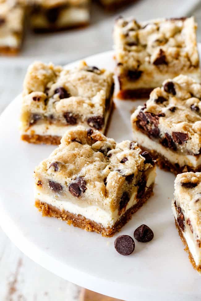 Chocolate Chip Cheesecake Bars on a a white pedestal