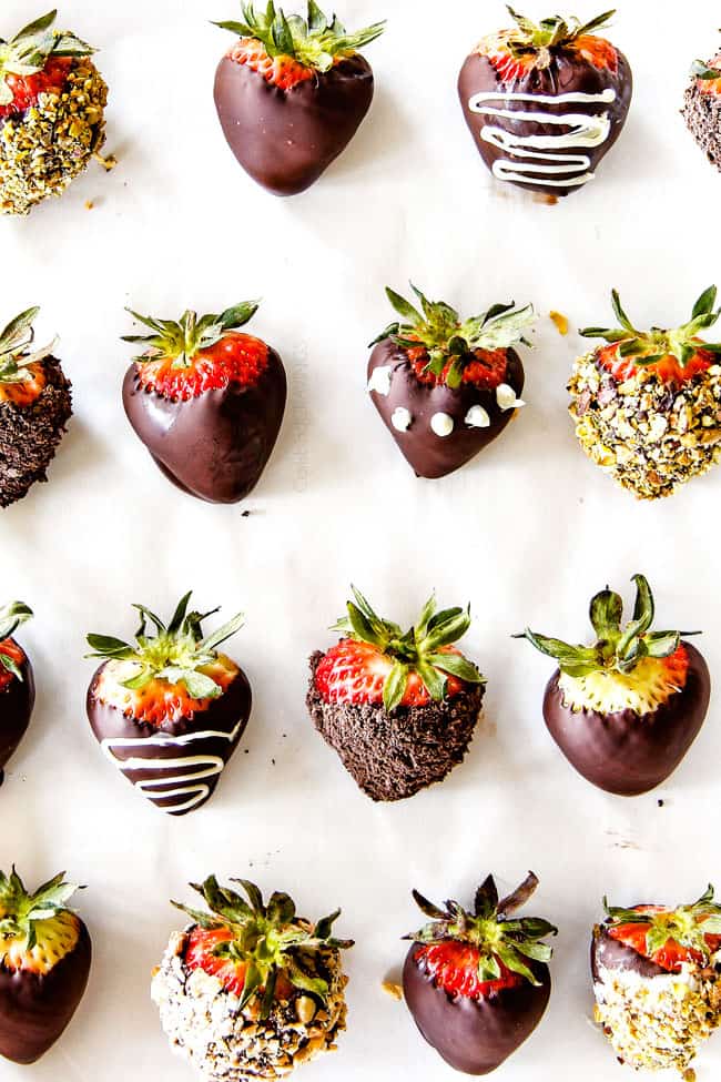 top view of chocolate covered strawberries with different coatings like white chocolate drizzle, white chocolate dos, pistachios