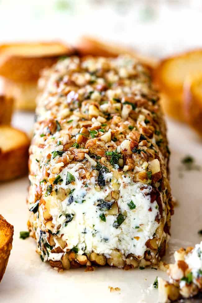 front shot of goat cheese log with garlic, zemon zest, basil, chives, parsley and rolled in pecans