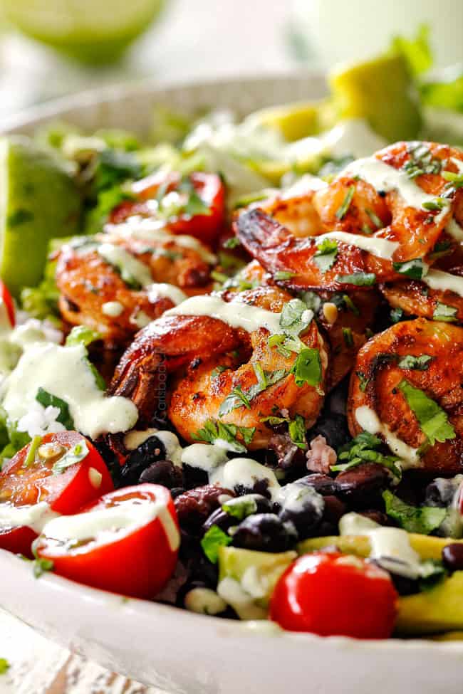 up close of chipotle shrimp burrito bowl drizzled with cilantro lime dressing