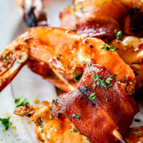 up close of best bacon wrapped shrimp with homemade cocktail sauce
